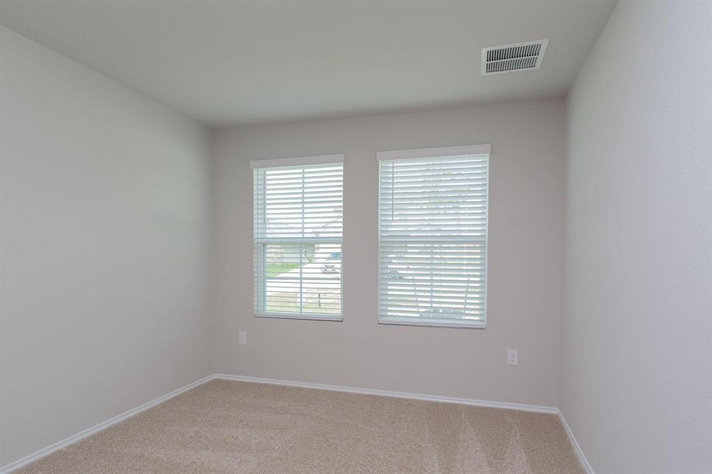 6009 Ronee Leah Drive Austin, TX 78724 - Photo 13 of 16 Ample natural light illuminates this cozy bedroom, perfect for a peaceful retreat.