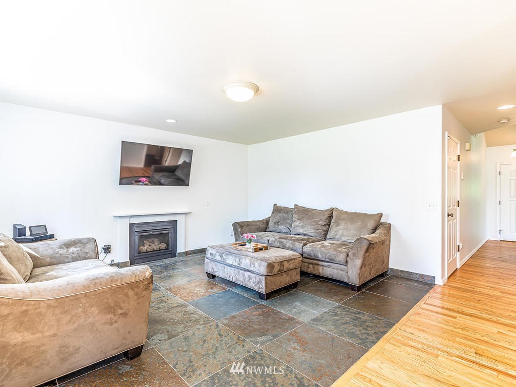 3220 228th Street Southeast Bothell, WA 98021 - Photo 12 of 35 a living room with furniture and a fireplace