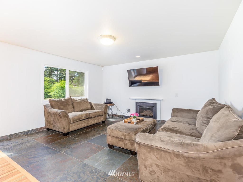 3220 228th Street Southeast Bothell, WA 98021 - Photo 13 of 35 a living room with furniture and a window