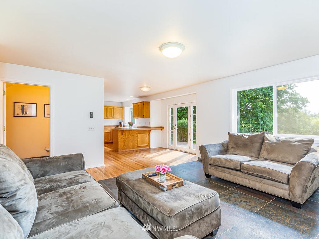 3220 228th Street Southeast Bothell, WA 98021 - Photo 14 of 35 a living room with furniture and a large window