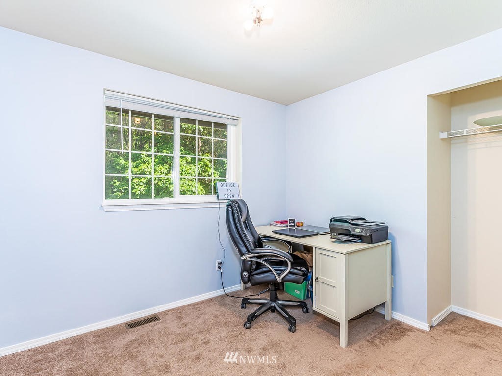 3220 228th Street Southeast Bothell, WA 98021 - Photo 19 of 35 a view of a workspace with furniture and a window