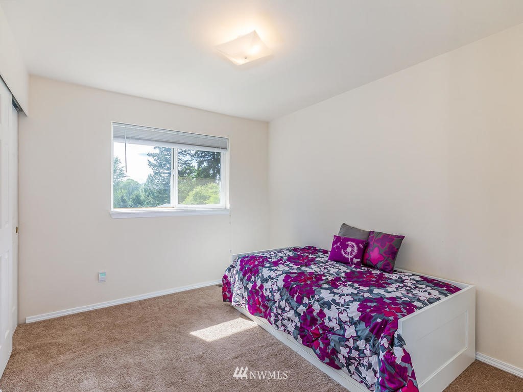 3220 228th Street Southeast Bothell, WA 98021 - Photo 20 of 35 a bedroom with a bed and a window