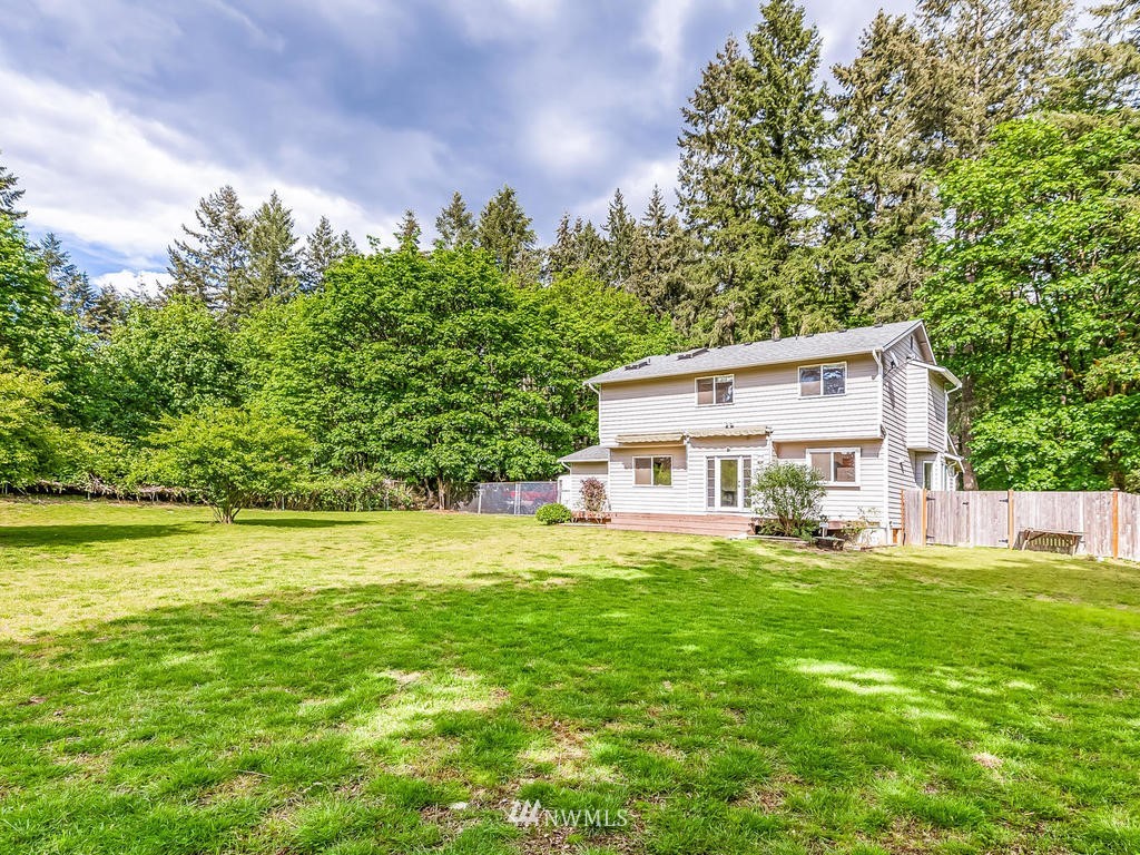 3220 228th Street Southeast Bothell, WA 98021 - Photo 28 of 35 a front view of a house with a yard and trees