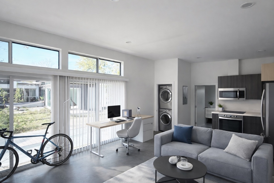 1155 Perry Road, Unit B Austin, TX 78721 - Photo 2 of 7 Office area with stacked washer and clothes dryer and concrete floors