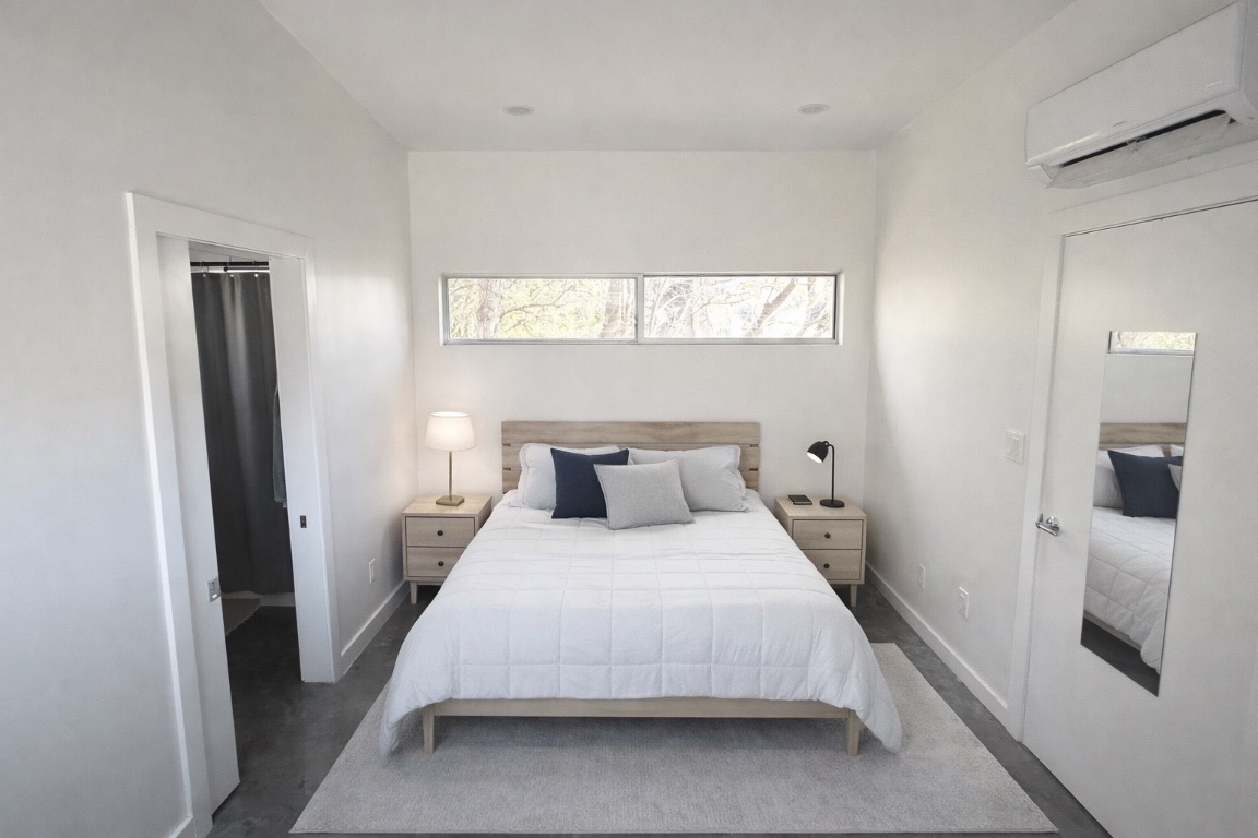 1155 Perry Road, Unit B Austin, TX 78721 - Photo 4 of 7 Bedroom with an AC wall unit and carpet flooring