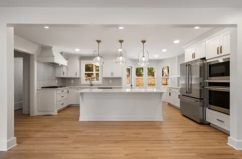 a large kitchen with stainless steel appliances kitchen island granite countertop a large counter top stainless steel appliances and cabinets