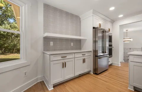 a kitchen with a refrigerator sink and stove