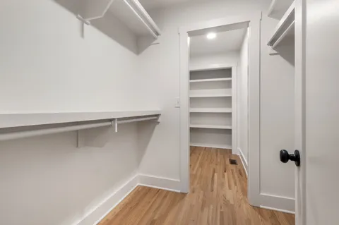a view of a room with wooden floor