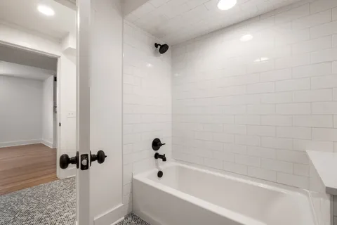 a bathroom with a bathtub and a shower