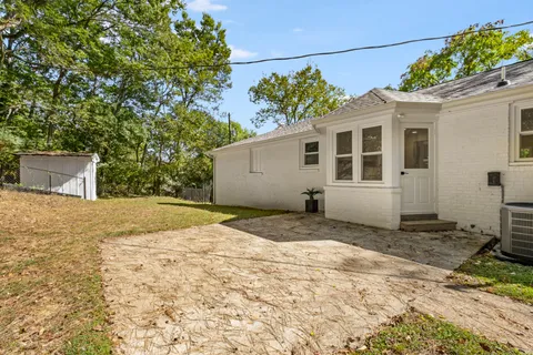 a view of a house with a yard and garage