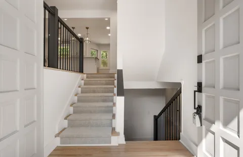 a view of entryway and hall with wooden floor