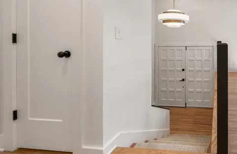 a view of a hallway with wooden floor