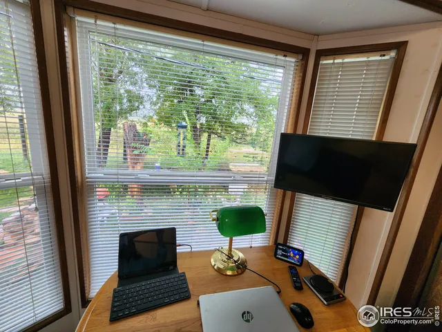 a living room with furniture floor to ceiling window hardwood floor and a fireplace