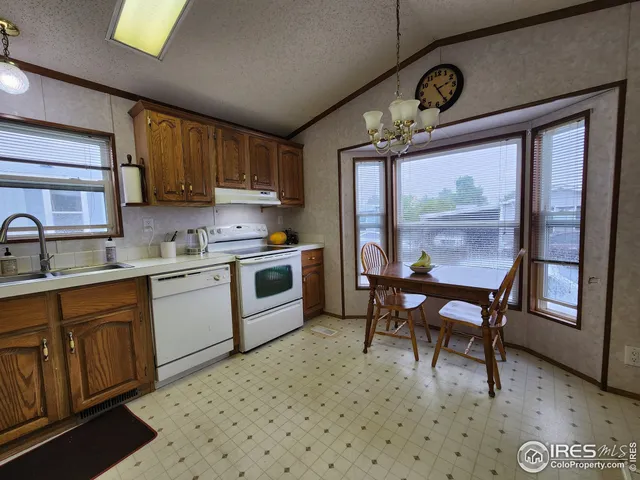 a kitchen with a sink appliances and cabinets