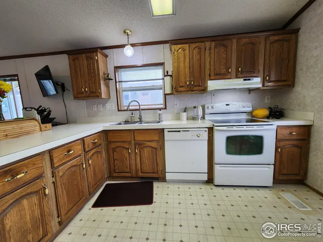 a kitchen with a cabinets and white appliances