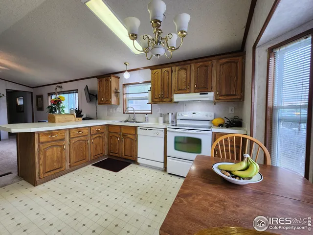 a kitchen with a sink window and cabinets