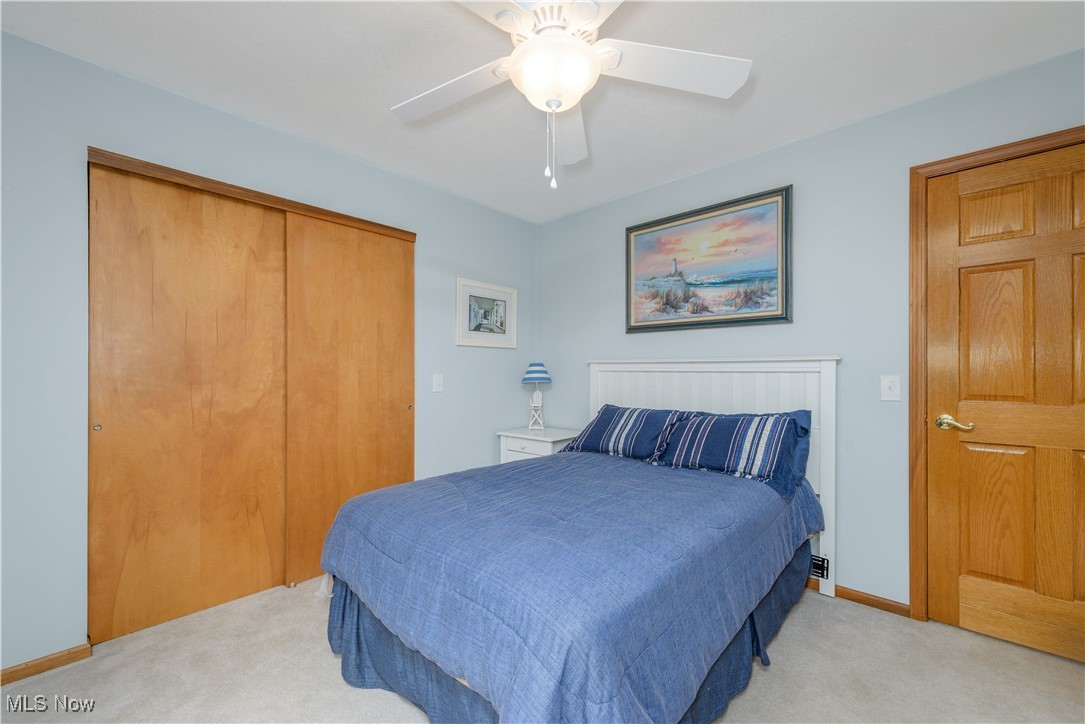 1435 Industry Road Atwater, OH 44201 - Photo 24 of 48 Carpeted bedroom featuring ceiling fan and a closet