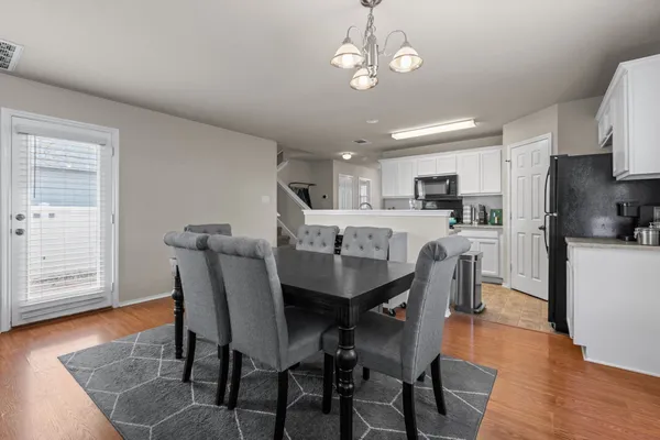 a view of a dining room with furniture and wooden floor