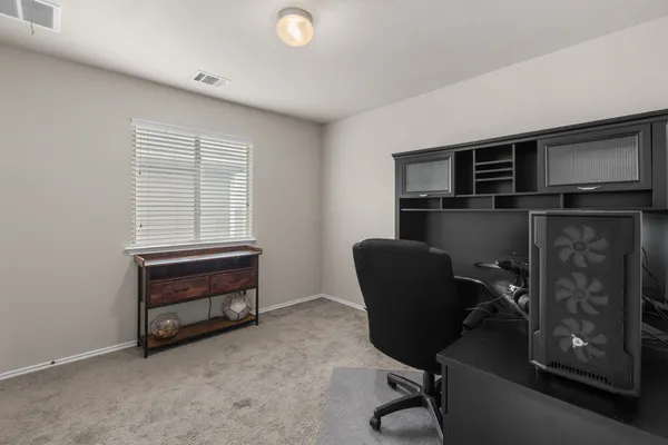 a large bed sitting in a bedroom next to a window with lamp