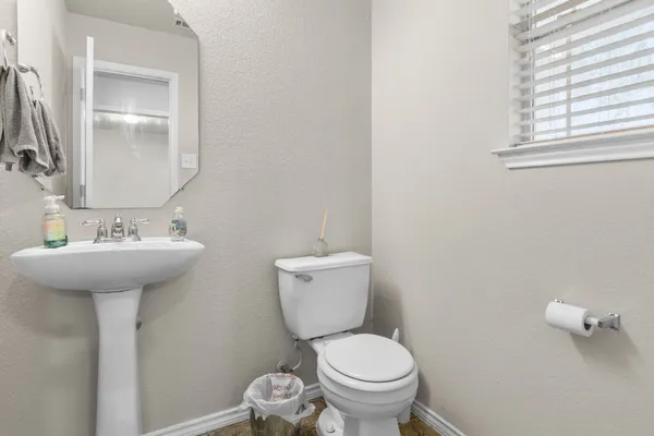a kitchen with stainless steel appliances granite countertop a refrigerator a sink a stove and a refrigerator