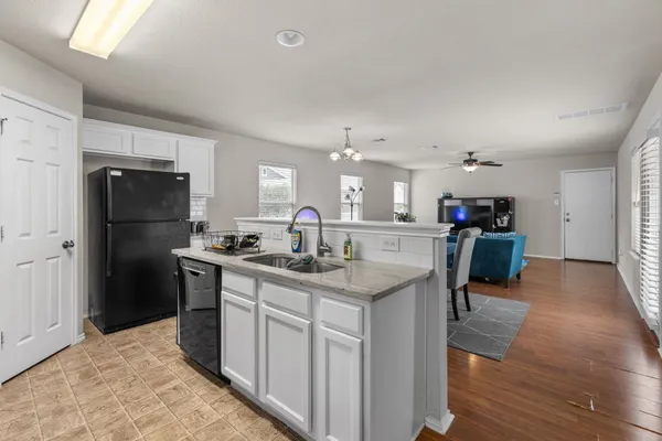 a kitchen with a refrigerator sink and stove