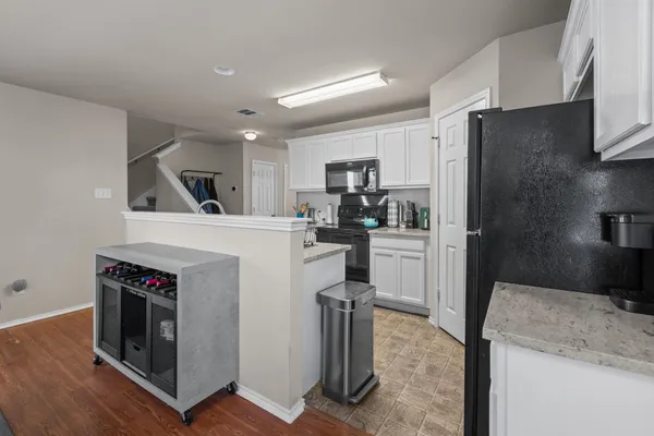 a kitchen with a stove a sink and a refrigerator
