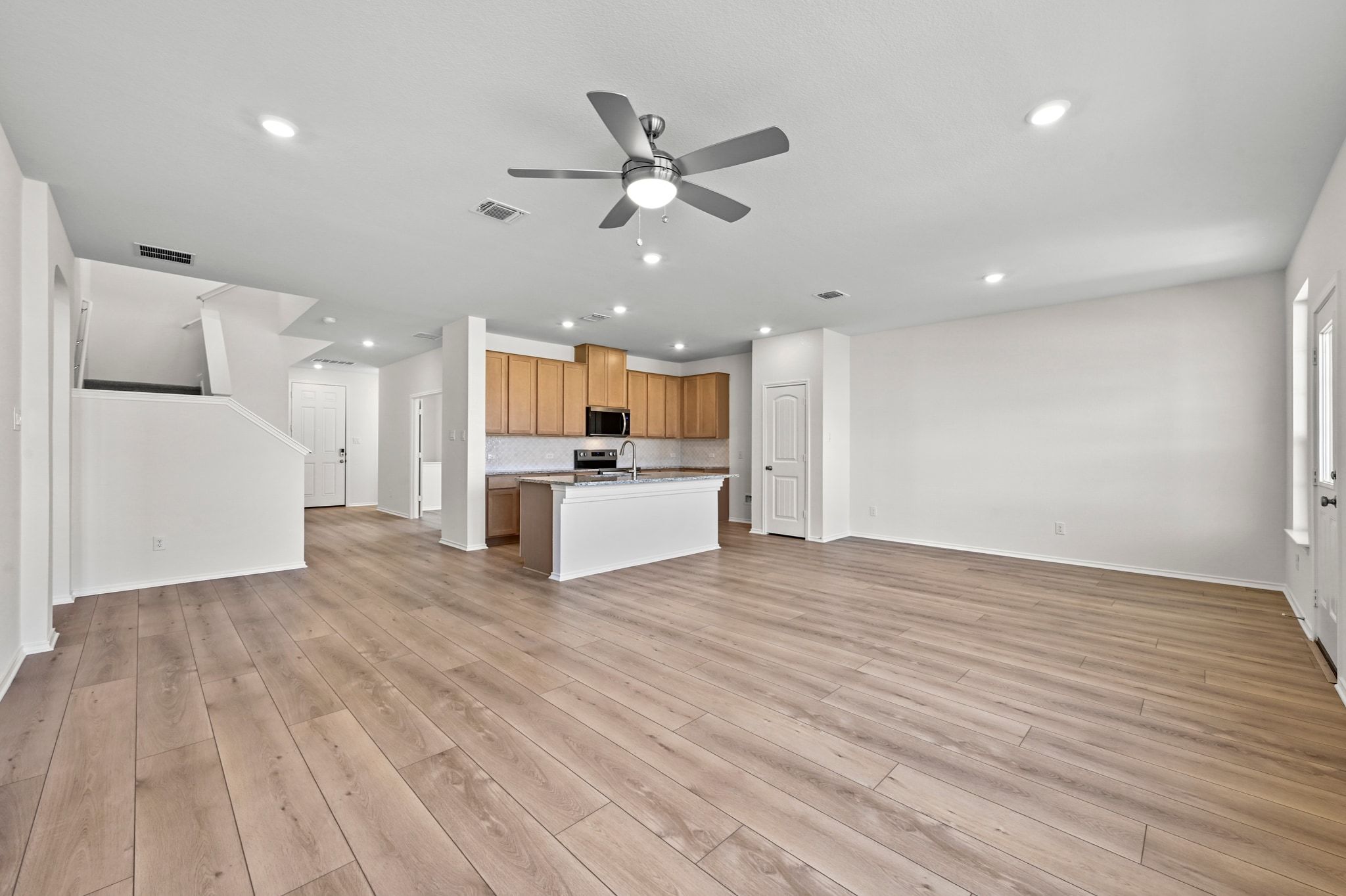 15004 Garrano Way Manor, TX 78653 - Photo 12 of 34 a view of a kitchen with a sink and a refrigerator