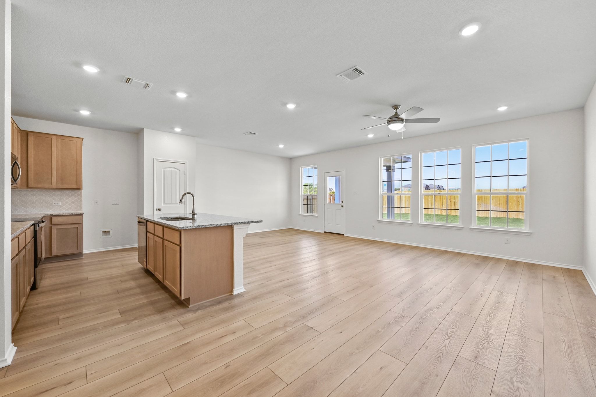 15004 Garrano Way Manor, TX 78653 - Photo 7 of 34 a view of an empty room with a window and wooden floor