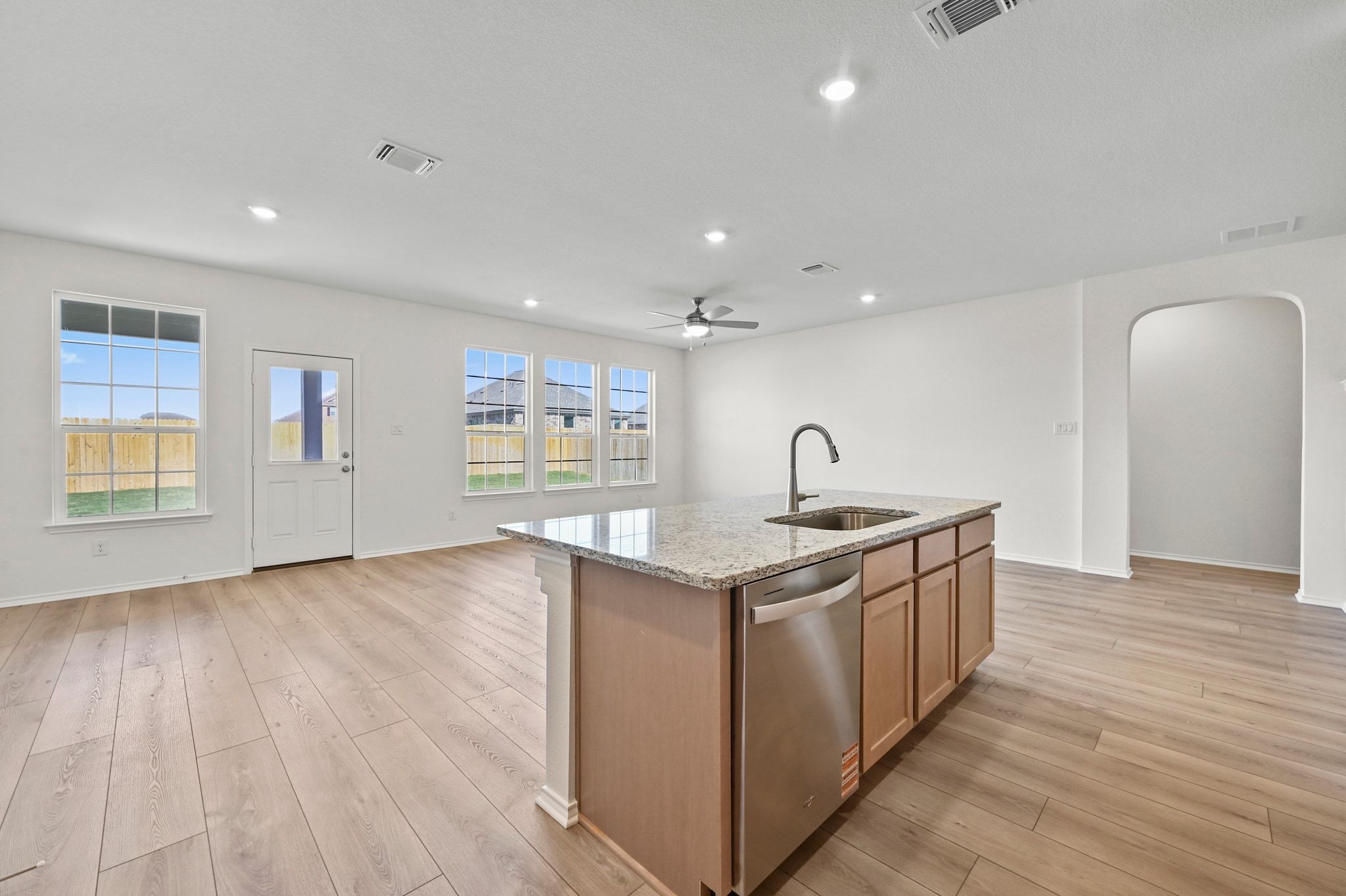 15004 Garrano Way Manor, TX 78653 - Photo 10 of 34 a kitchen with granite countertop a sink and a stove top oven