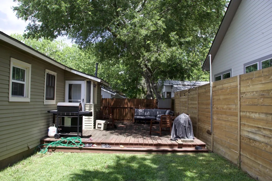 1200 Alegria Road, Unit 1 Austin, TX 78757 - Photo 13 of 16 Fenced backyard with a wooden deck