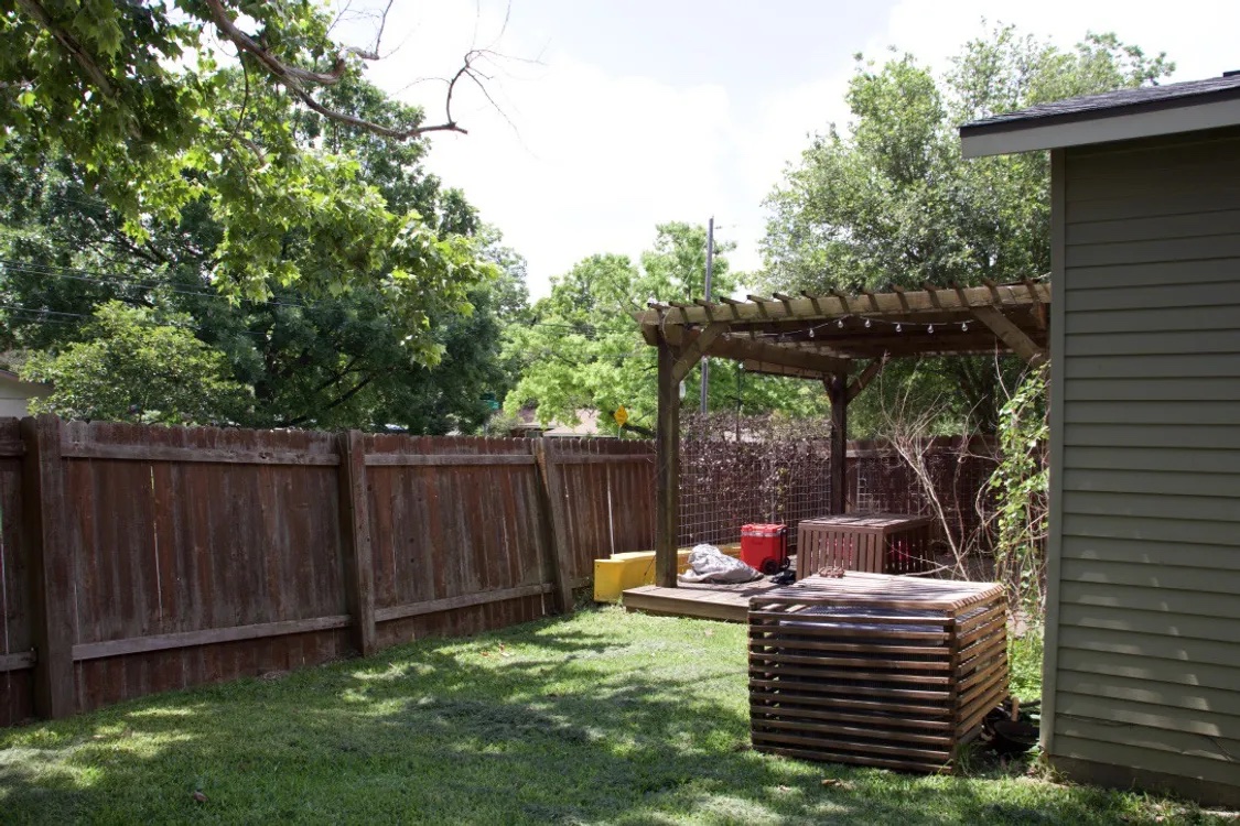 1200 Alegria Road, Unit 1 Austin, TX 78757 - Photo 16 of 16 Fenced backyard featuring a pergola and a patio area.
