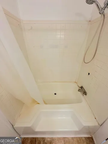 a bathroom with a granite countertop toilet and a sink