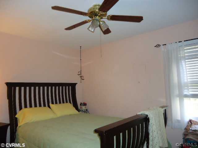 3904 Echo Ridge Court Midlothian, VA 23112 - Photo 3 of 7 a bedroom with a bed and a chandelier