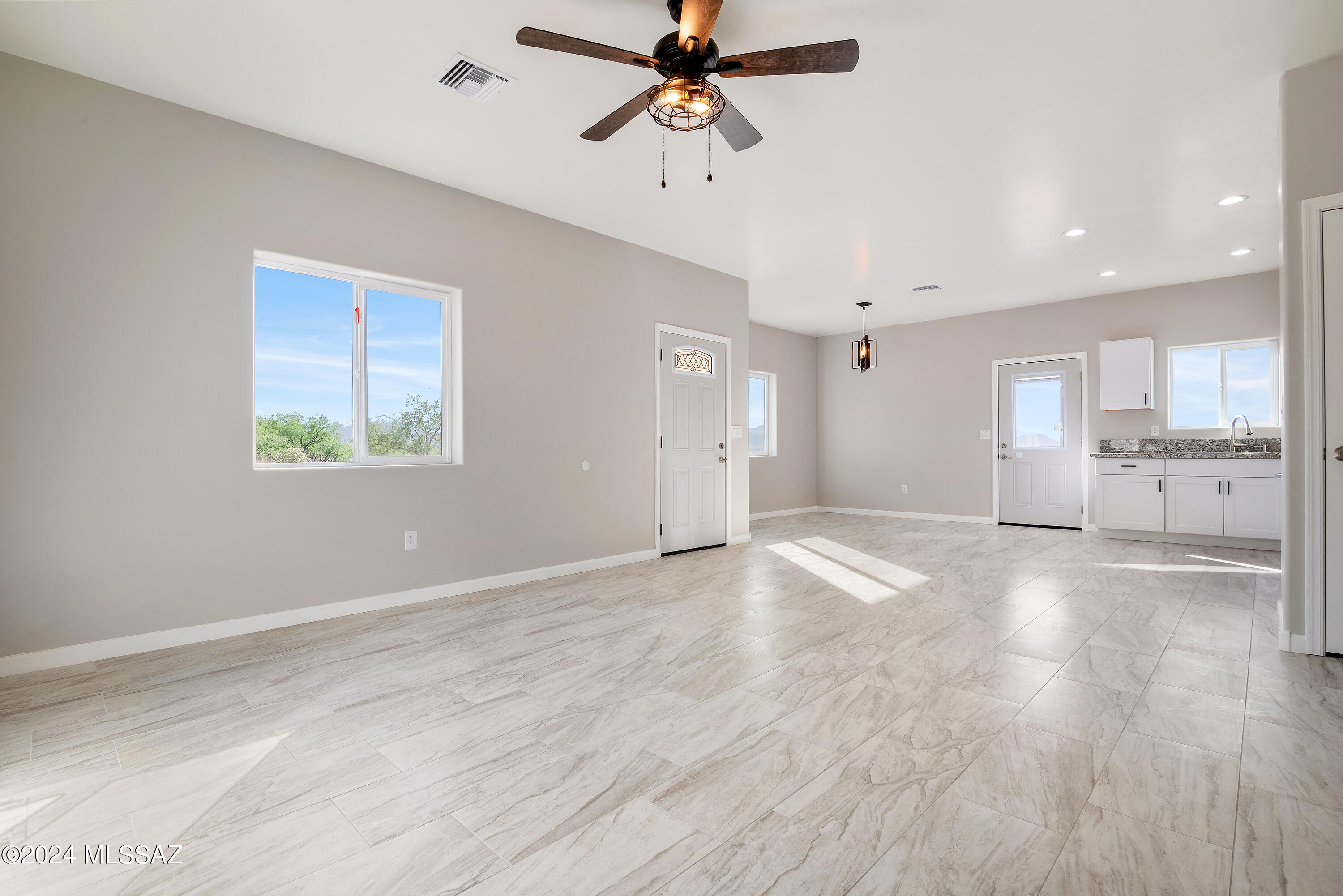 162 Camino Embarcadero Rio Rico, AZ 85648 - Photo 14 of 35 a view of an empty room with window and wooden floor