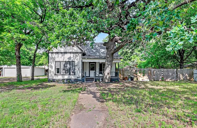 a front view of a house with patio and garden