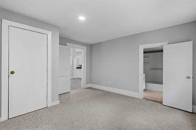 a view of an empty room and closet area