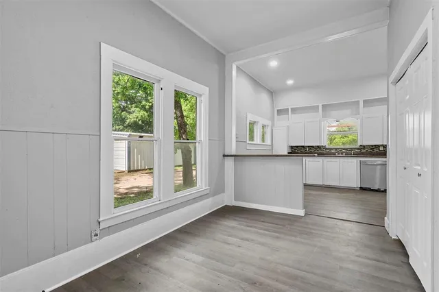 a kitchen with stainless steel appliances granite countertop a stove a sink and a large window