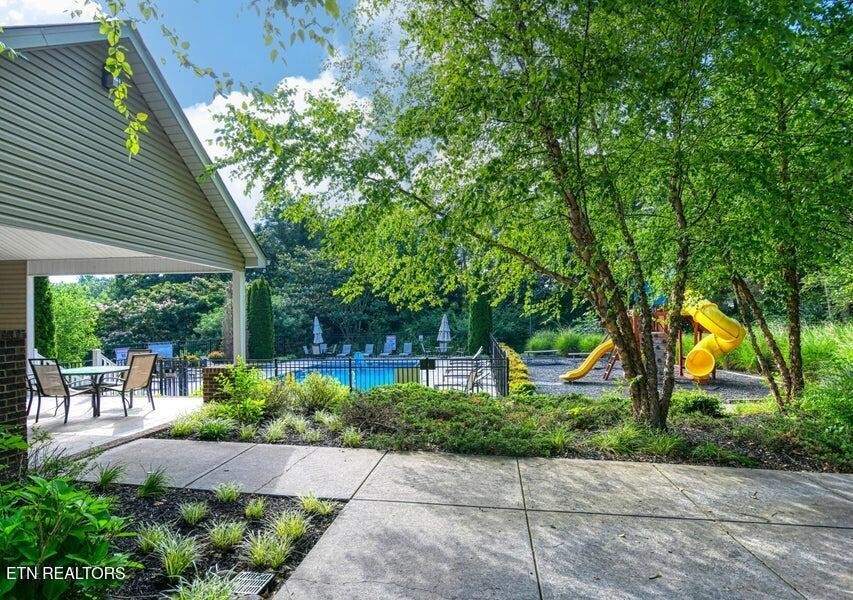8508 Bowsong Lane Powell, TN 37849 - Photo 24 of 28 a view of a patio with table and chairs potted plants and large tree