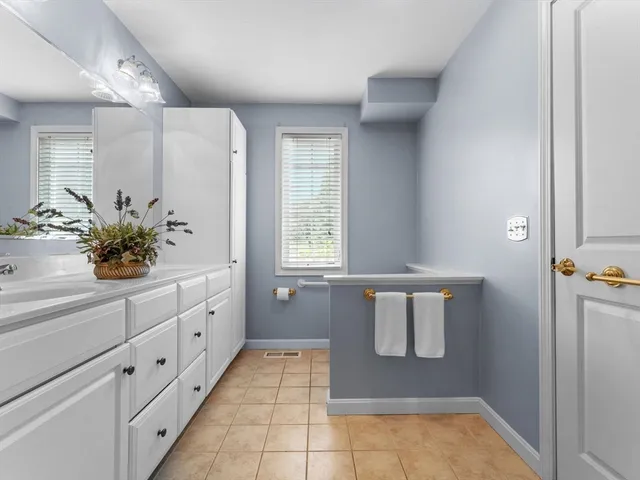a bathroom with a bathtub sink and mirror
