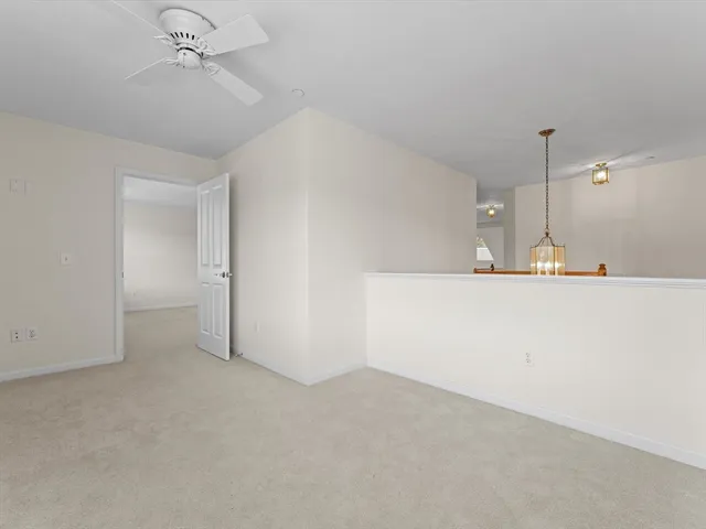 a view of a kitchen with a sink and chandelier fan