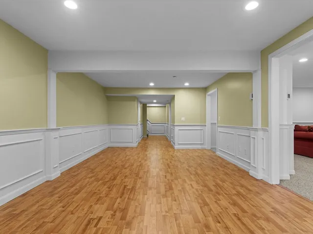a view of a livingroom with wooden floor and staircase