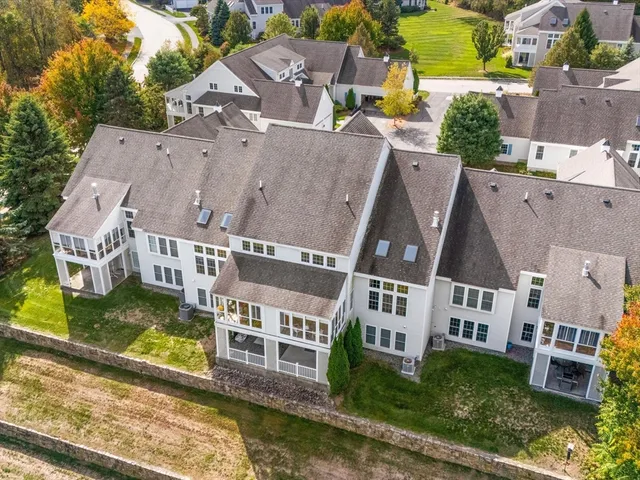 an aerial view of residential houses with yard