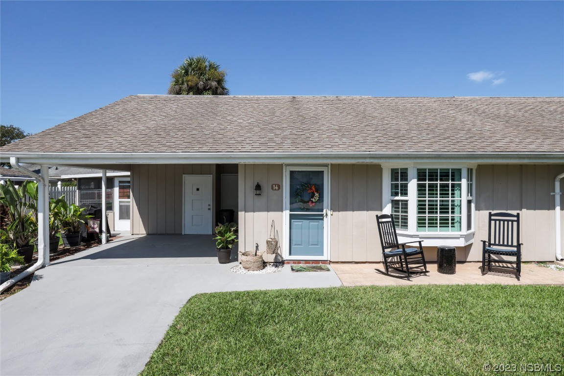 14 Chip Lane New Smyrna Beach, FL 32168 - Photo 1 of 54 a front view of a house with a garden and porch