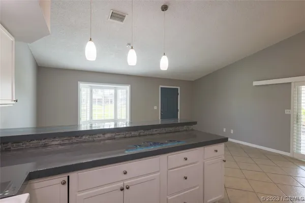 a kitchen with granite countertop cabinets and window