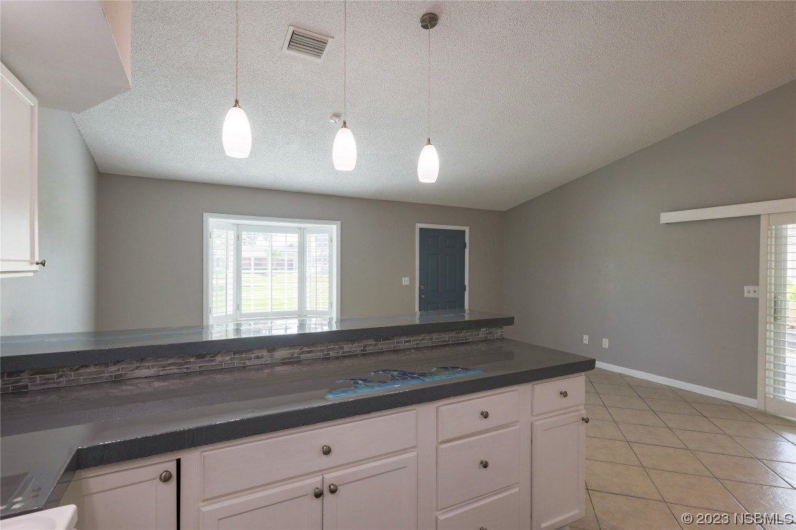 14 Chip Lane New Smyrna Beach, FL 32168 - Photo 11 of 54 a kitchen with granite countertop cabinets and window