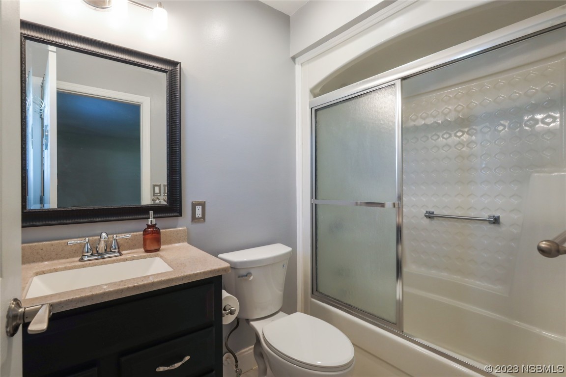 14 Chip Lane New Smyrna Beach, FL 32168 - Photo 15 of 54 a bathroom with a sink a toilet and shower