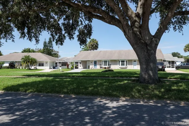 a front view of a house with a yard porch and outdoor seating
