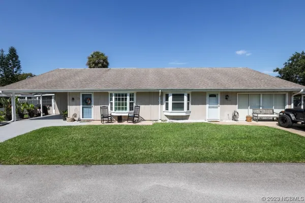 a front view of a house with a garden and porch