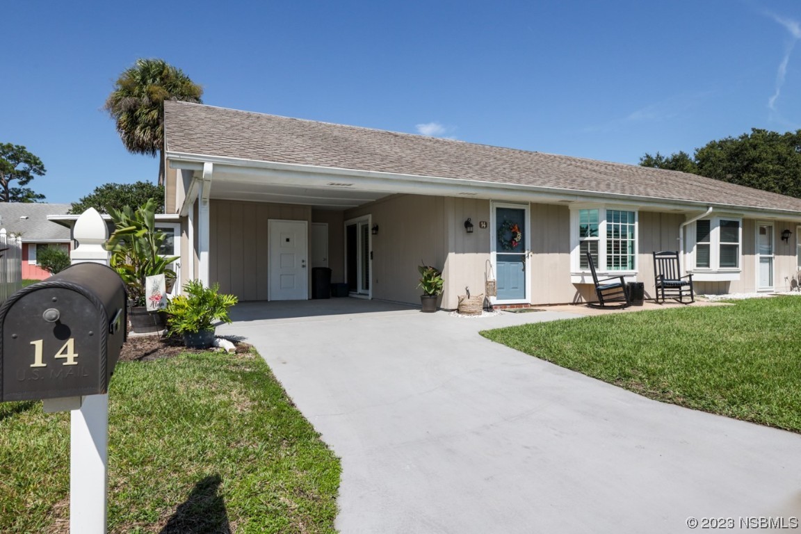 14 Chip Lane New Smyrna Beach, FL 32168 - Photo 31 of 54 a view of a house with porch and garden
