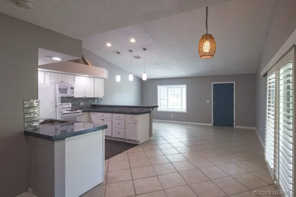 a kitchen with stainless steel appliances a sink stove and cabinets